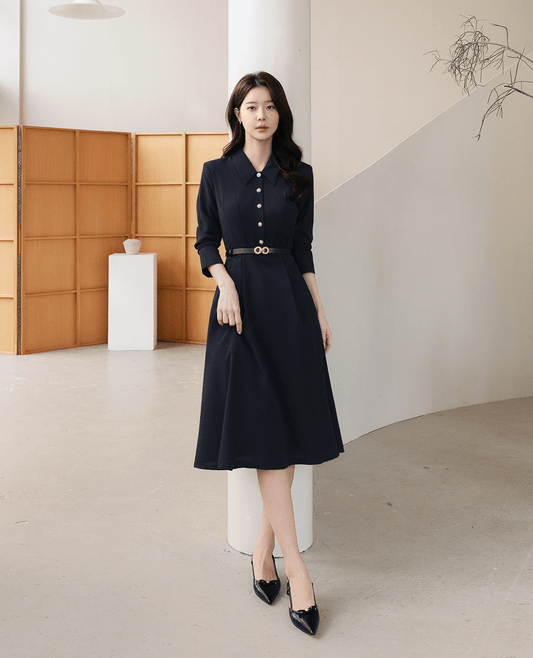 Elegant navy flare dress with long sleeves, belted waist, and structured collar. Perfect for polished occasions and transitional weather.