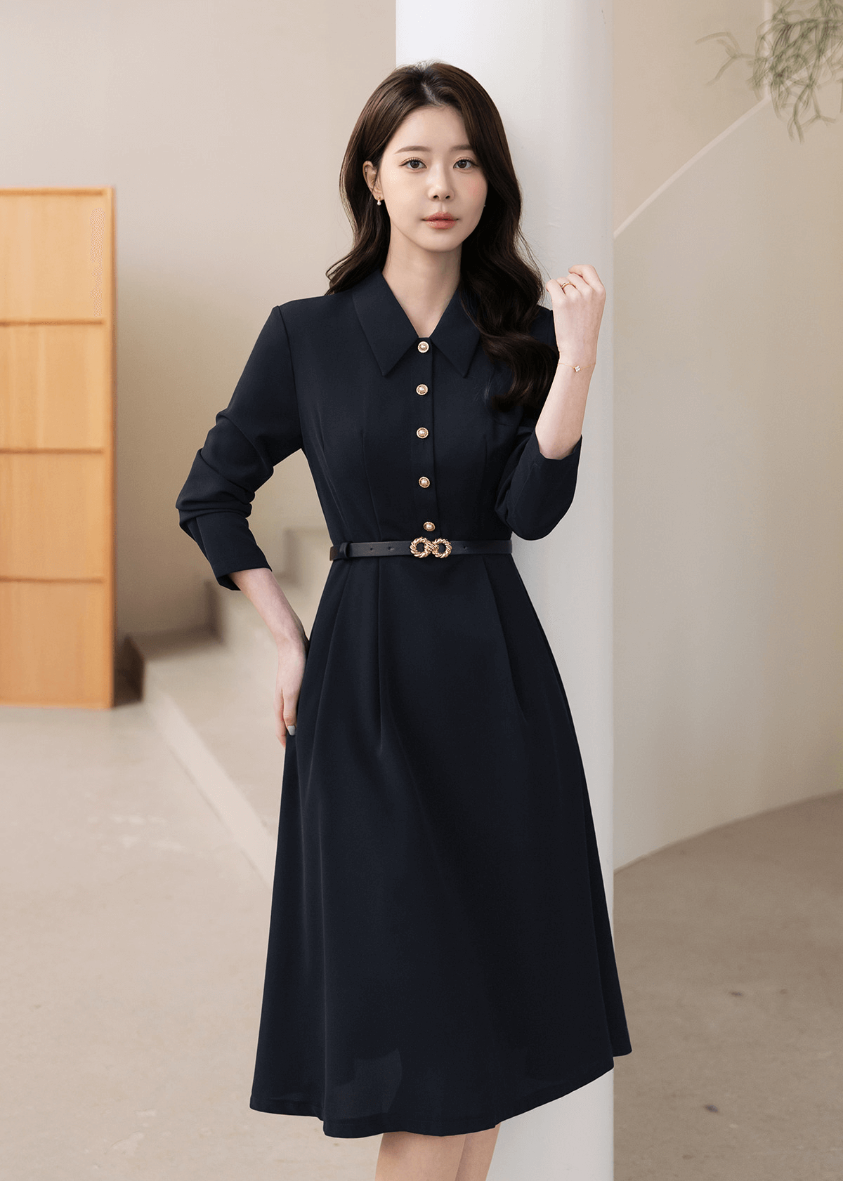 Elegant navy flare dress with long sleeves, structured collar, and belted waistline, perfect for polished occasions.
