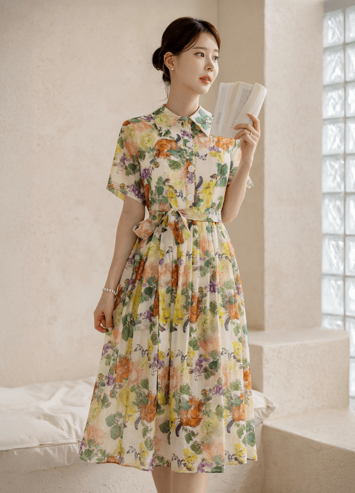 Woman wearing a romantic floral dress with pintuck detail and collar neckline, embodying elegance and grace.