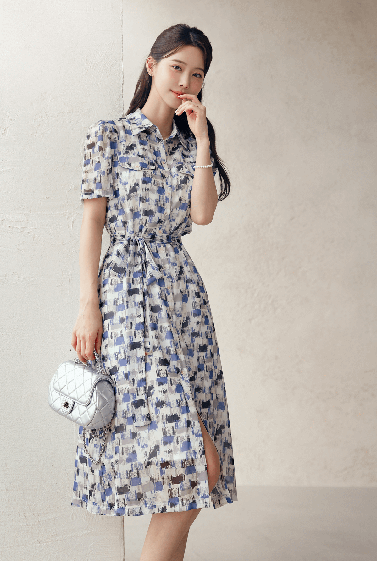 Woman wearing a Breezy Chiffon Shirt Dress with Belt in blue abstract pattern, showcasing summer style and feminine silhouette.