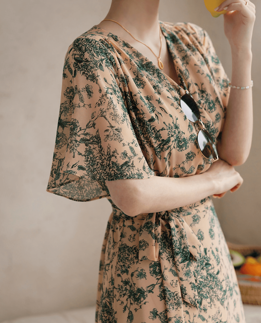 Goddess-inspired wrap dress with floral print, graceful wing sleeves, and elegant ribbon tie, perfect for a feminine silhouette.