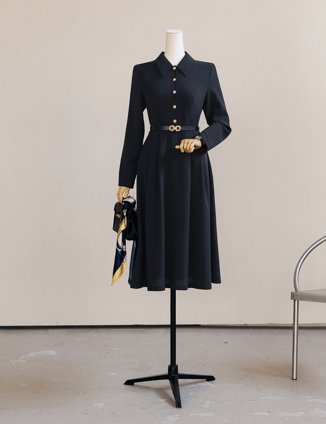Elegant navy flare dress with long sleeves, belted waist, and A-line silhouette on a mannequin.