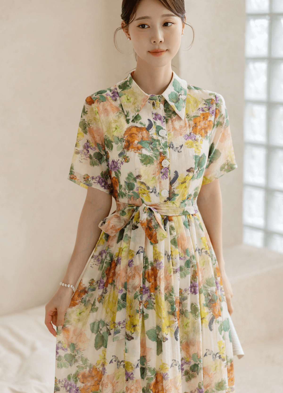 Romantic floral dress with pintuck detail and collar neckline, featuring a colorful print and soft flare silhouette.