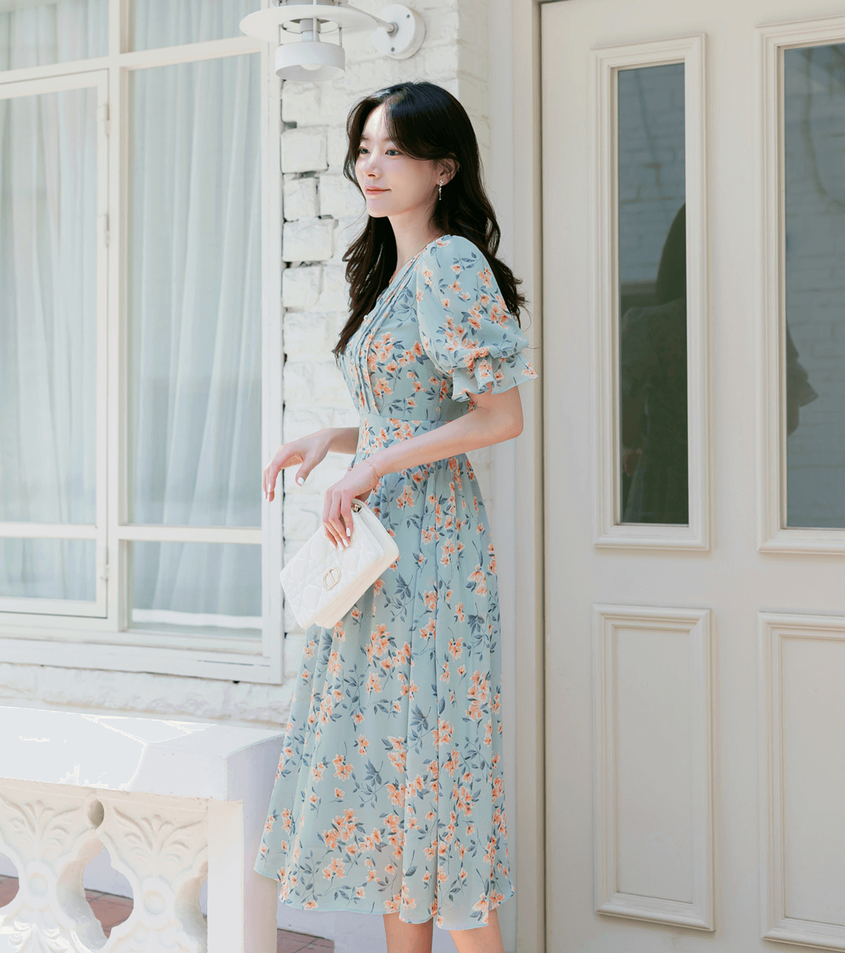 V-neck puff sleeve floral chiffon dress in breezy blue, worn by a woman outdoors, showcasing airy design and summer style elegance.