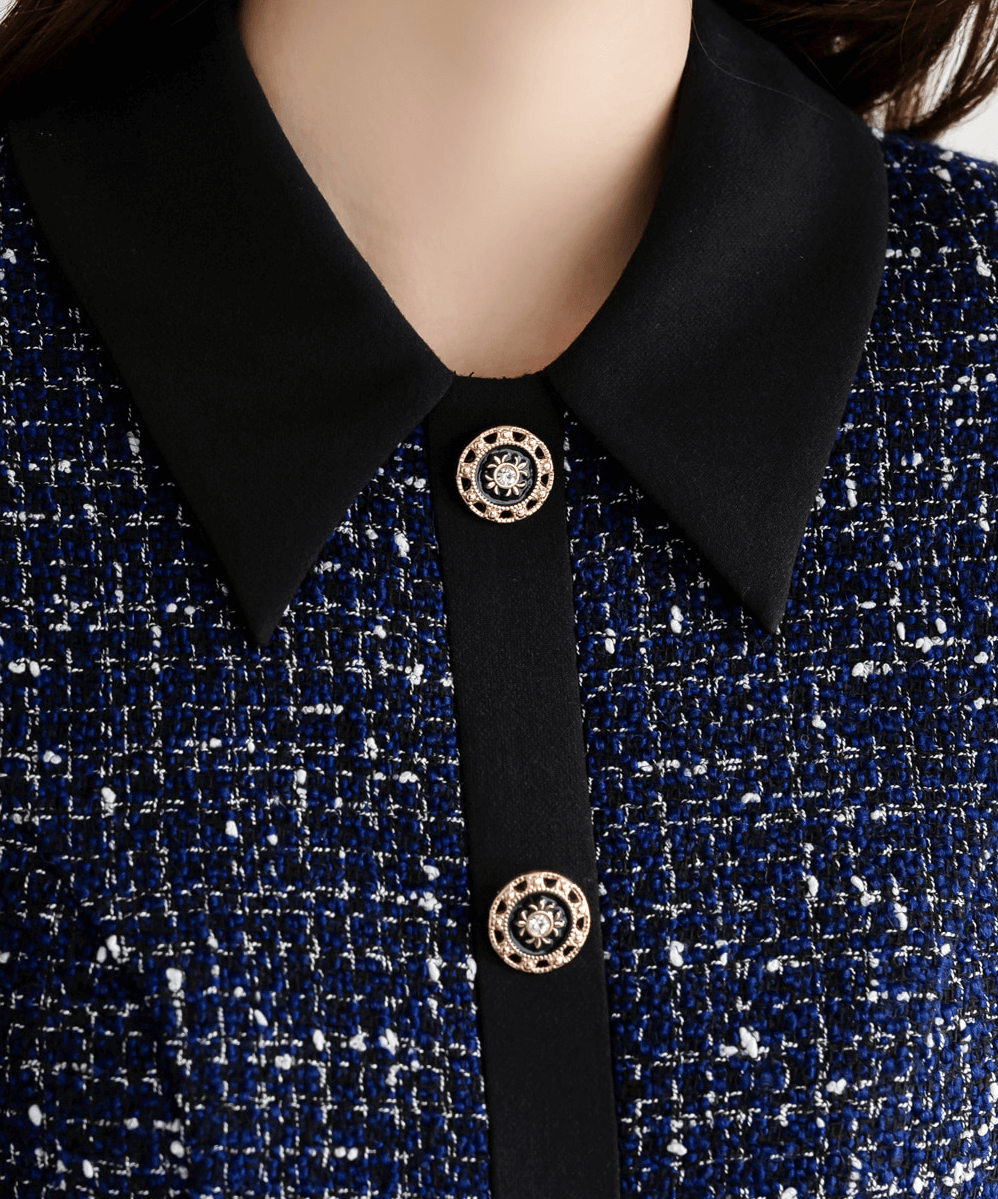 Two-tone tweed and black dress with gold button detail, featuring navy tweed top and black collar.