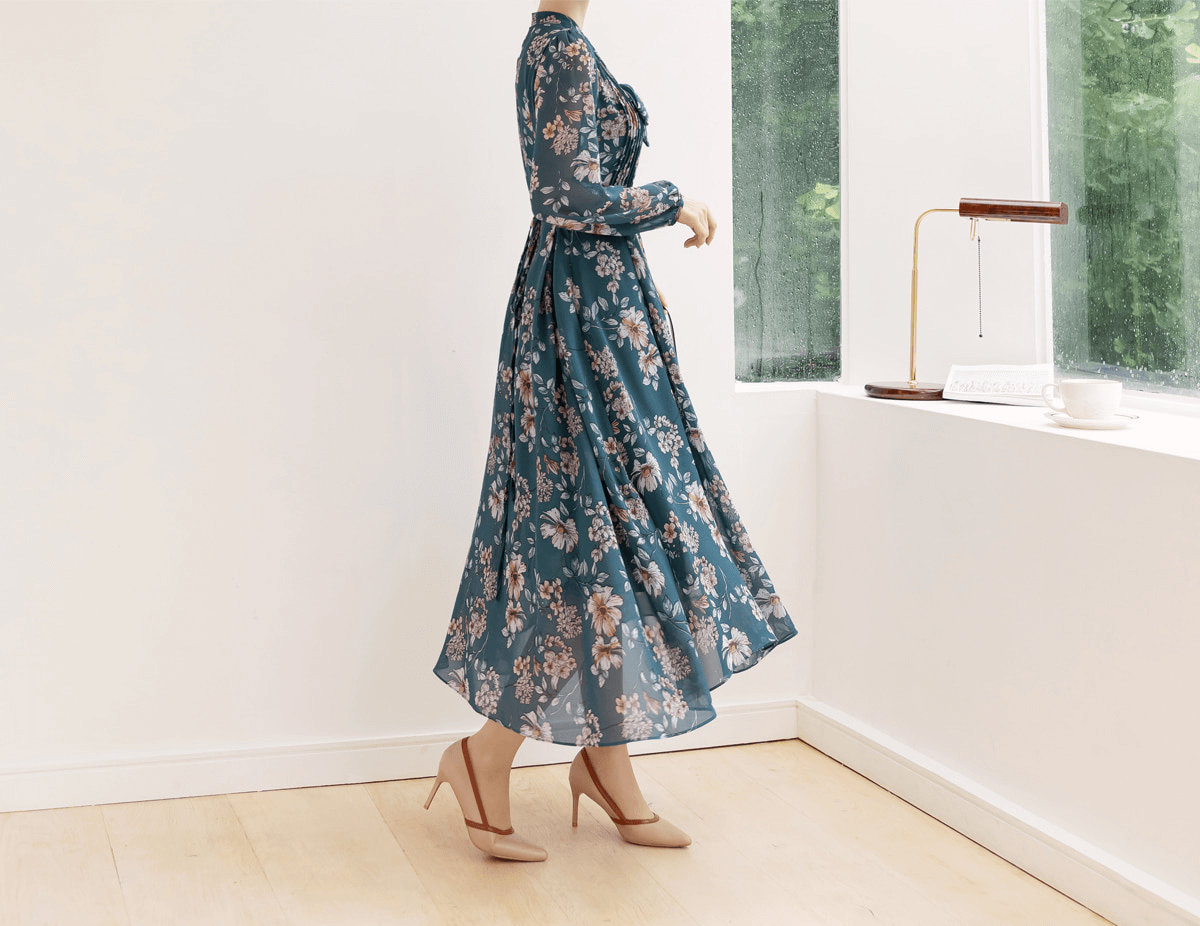 Floral chiffon flare dress with V-neck and convertible neck tie, elegant side view in a bright room with natural light.