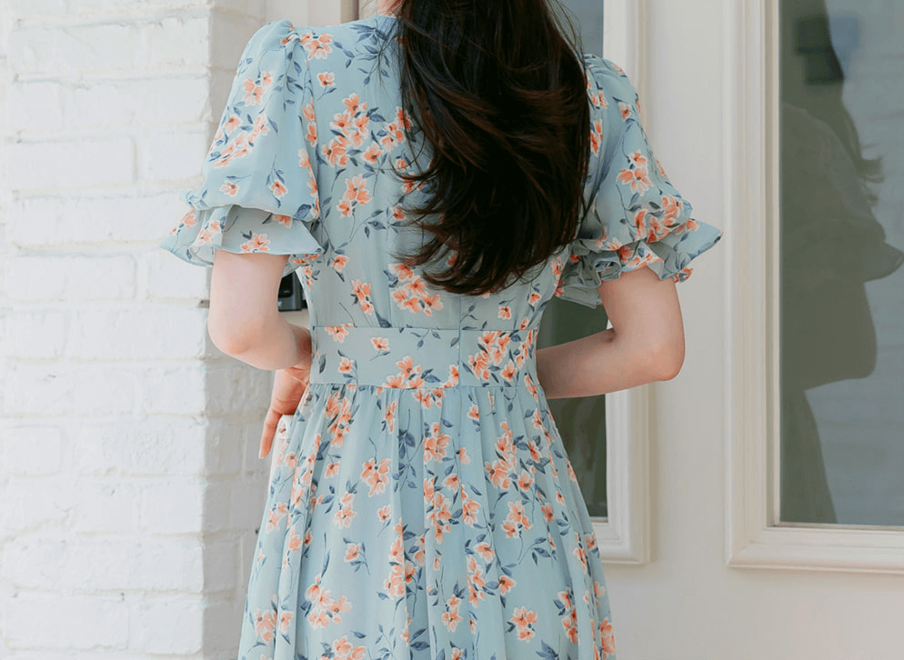 Back view of a V-neck puff sleeve floral chiffon dress in breezy blue, showing soft floral print and gathered waist for spring style.