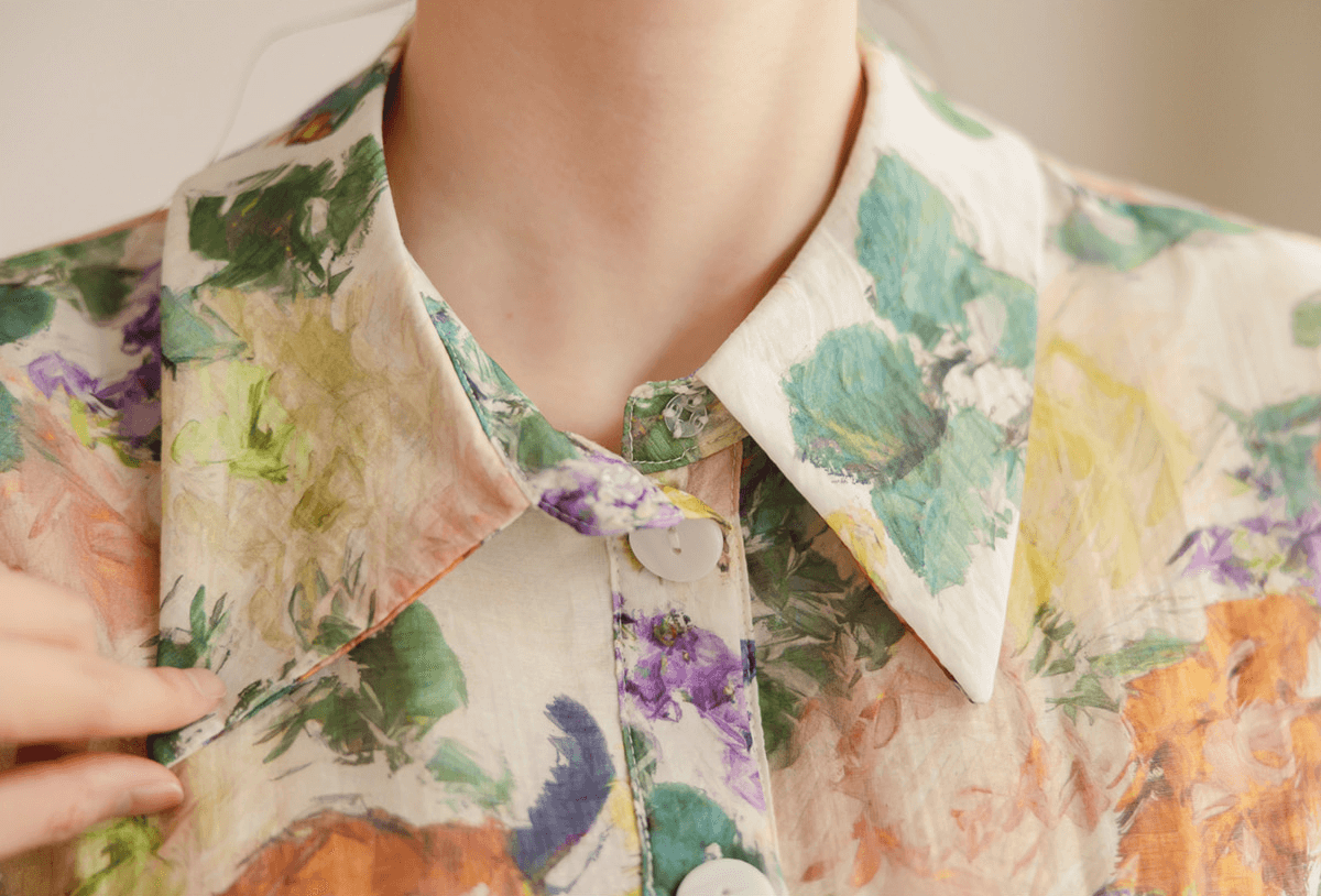 Close-up of collar neckline on romantic floral dress with pintuck detail, featuring vibrant floral print and tailored elegance.