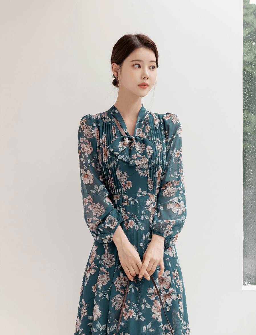 Floral chiffon flare dress with V-neck and convertible neck tie, worn by model. Feminine and elegant fashion style.