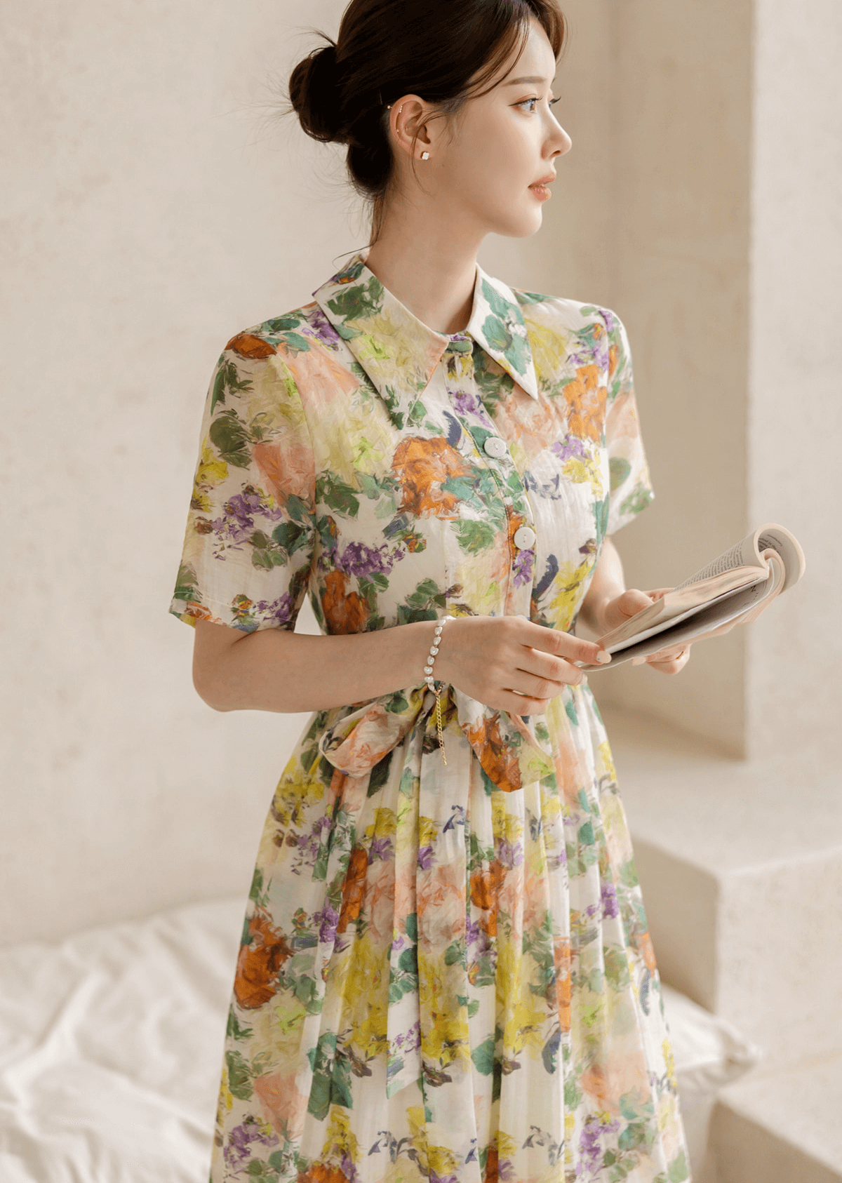 Woman wearing a romantic floral dress with pintuck detail and collar neckline, exuding elegance and femininity.