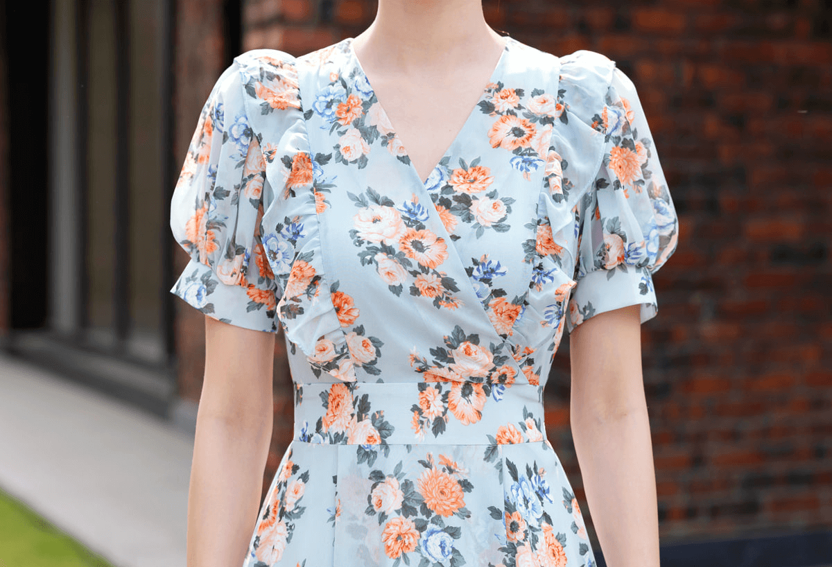 Romantic floral chiffon dress with short puff sleeves and V-neckline in blue, showcasing a spring-inspired floral design.