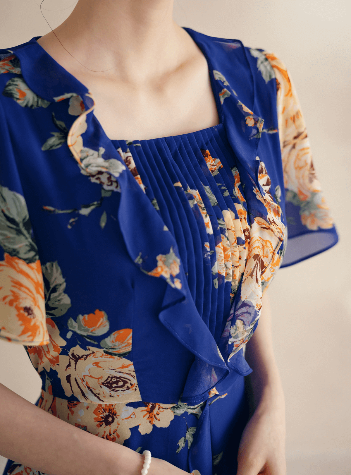 Floral chiffon dress with sheer wing sleeves and square neckline, featuring a blue base and delicate floral pattern.