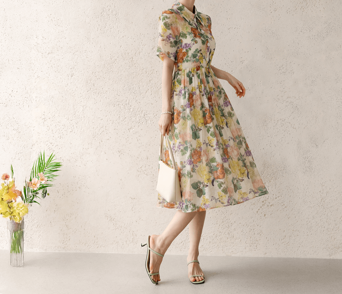 Romantic floral dress with pintuck detail and collar neckline, showcasing soft flare silhouette and subtle floral print.