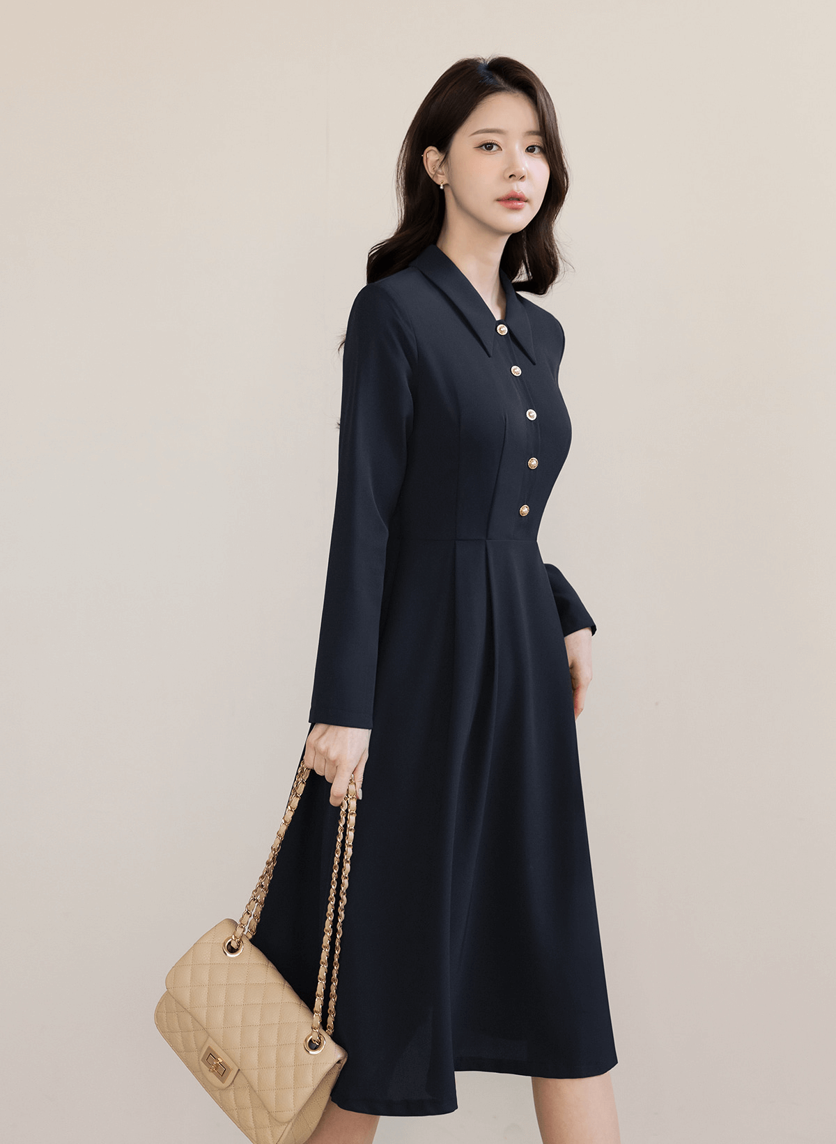 Elegant navy flare dress with long sleeves and belted waist, perfect for transitional seasons and polished occasions.