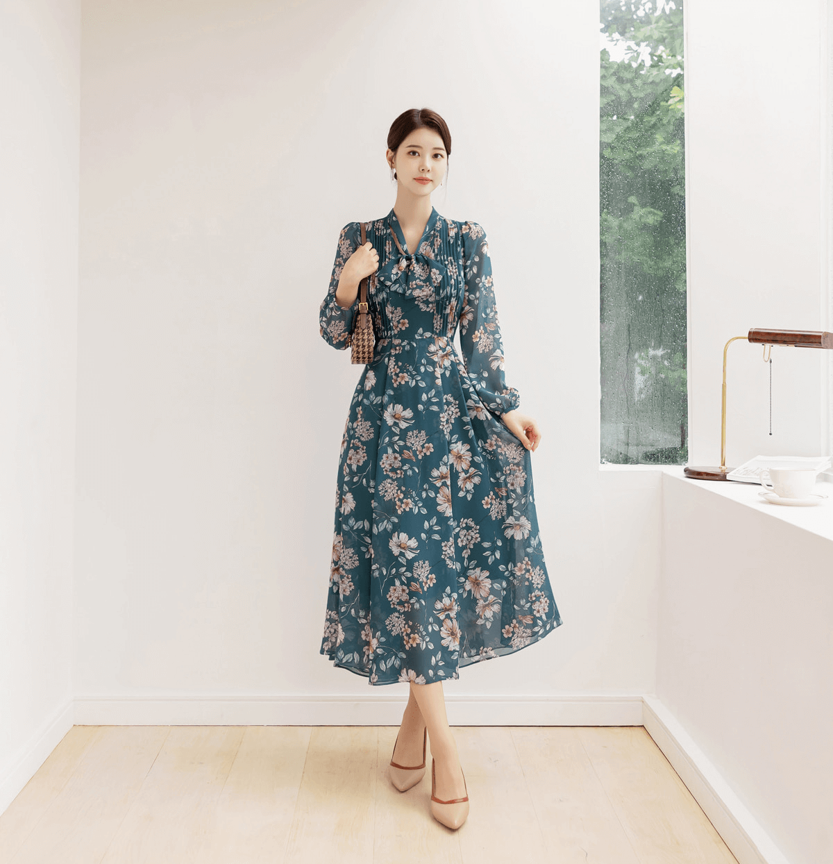 Woman wearing a floral chiffon flare dress with V-neck and convertible neck tie, featuring a feminine design and elegant styling.