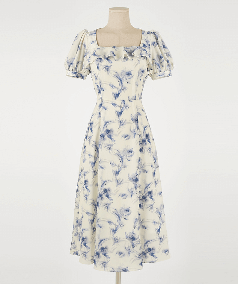 Elegant chiffon dress with blue-violet abstract print and square ruffle neckline on ivory base.