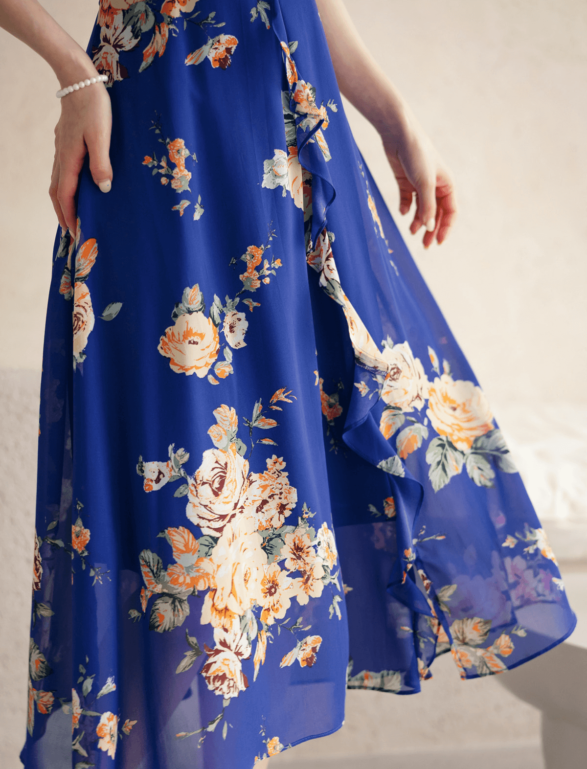 Blue floral chiffon dress with sheer wing sleeves, square neckline, and flowing skirt, showcasing a romantic and ethereal design.