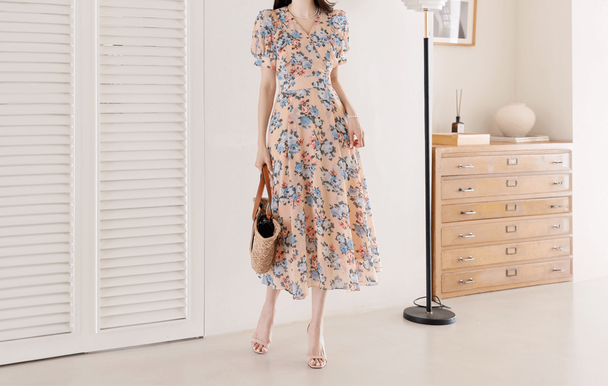 Romantic floral chiffon dress with V-neckline, short puff sleeves, and high waist. Available in pink and blue for a stylish spring look.