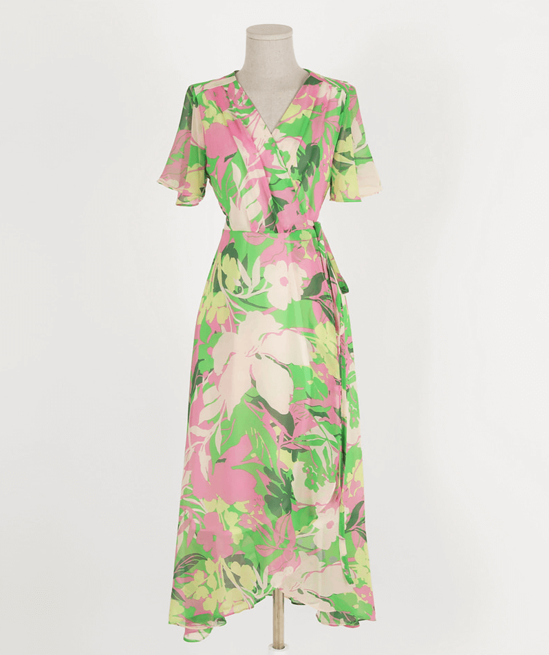 Chiffon wrap dress with tulip hem, green base, pink and yellow floral pattern, and feminine silhouette.
