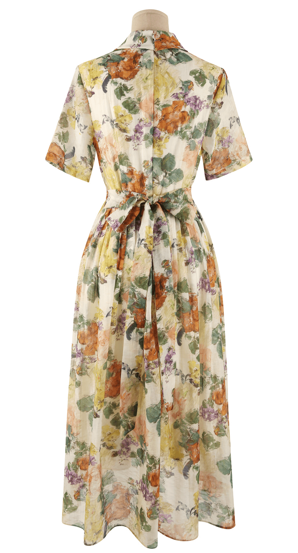 Back view of romantic floral dress with pintuck detail, collar neckline, and soft flare silhouette featuring a dreamy floral print.