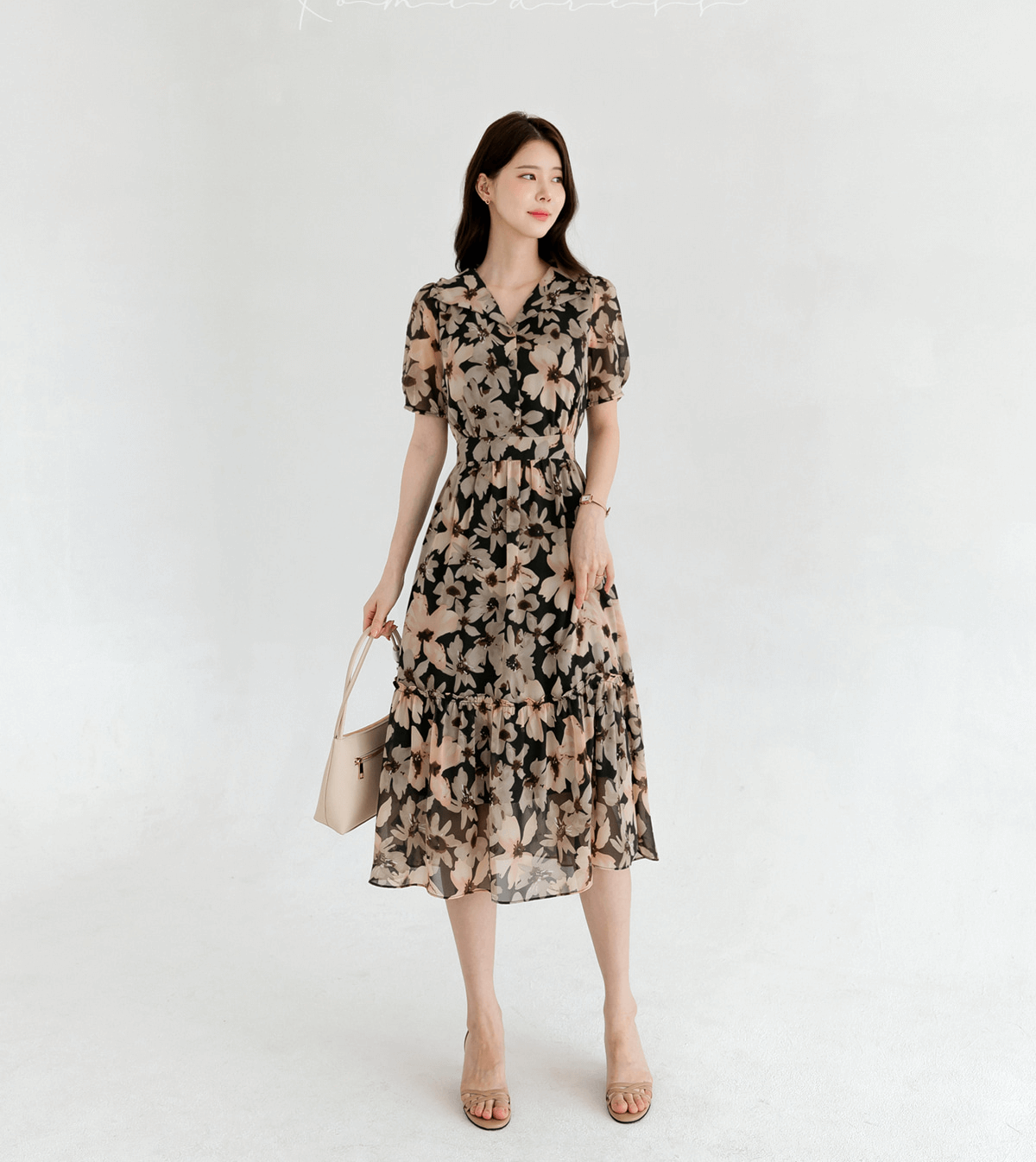 Model wearing a floral chiffon dress with a wide flat collar and puff short sleeves, showcasing feminine charm and airy elegance.