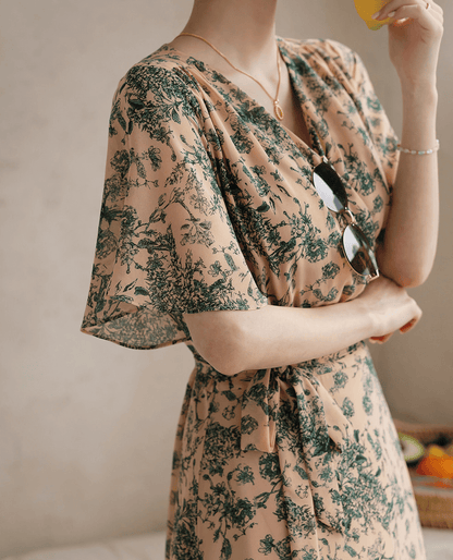 Goddess-inspired wrap dress with floral print, graceful wing sleeves, and elegant ribbon tie, perfect for a feminine silhouette.