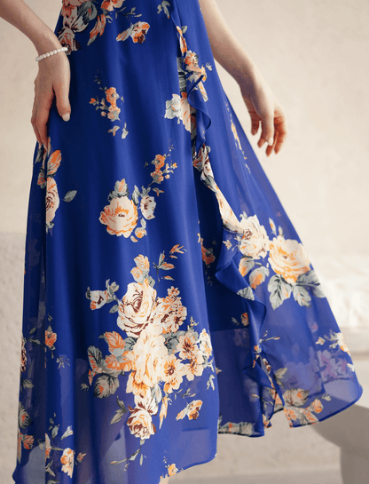 Blue floral chiffon dress with sheer wing sleeves, square neckline, and flowing skirt, showcasing a romantic and ethereal design.