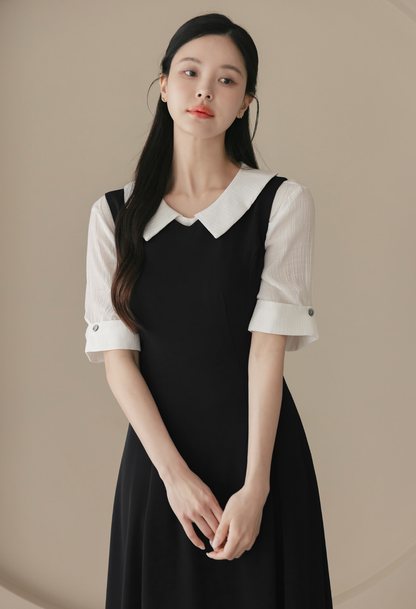 Elegant Sleeveless Black Flare Dress with V-Neck and Wide Shoulder Line
