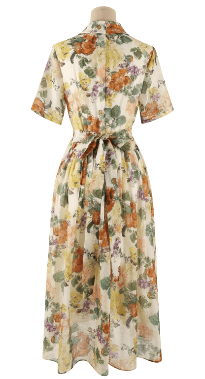 Back view of romantic floral dress with pintuck detail, collar neckline, and soft flare silhouette featuring a dreamy floral print.